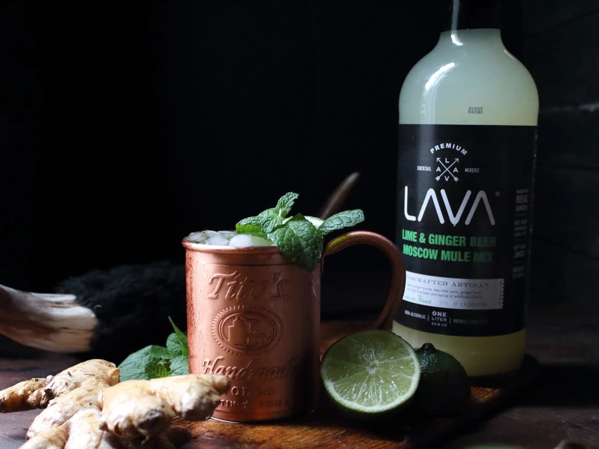 An alcohol-free mule in a copper mug with a lime wheel and crushed ice
