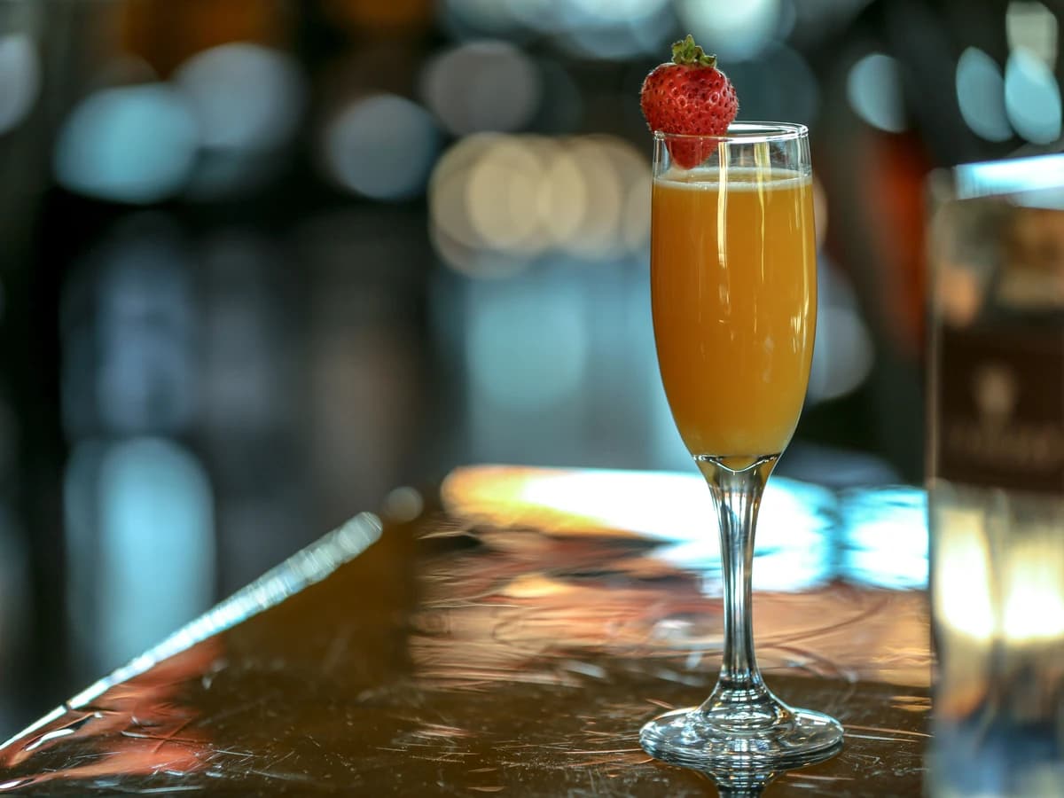 A pale peach-pink Bellini in a champagne flute