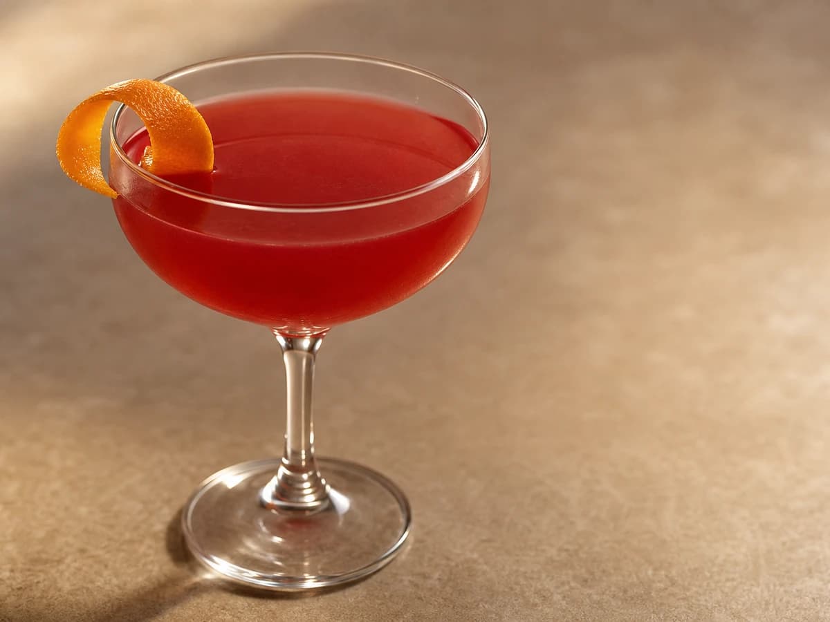 An alcohol-free Cosmopolitan in a chilled coupe, pale pink with an orange twist