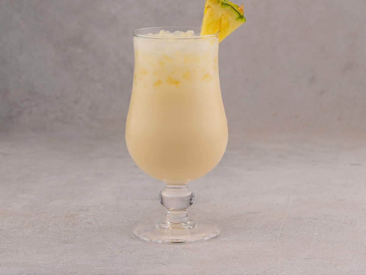 A Painkiller in a tiki mug over crushed ice, dusted generously with fresh grated nutmeg